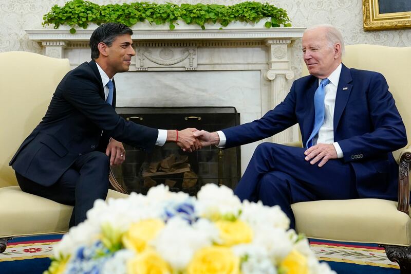 U.S. President Joe Biden and U.K. Prime Minister Rishi Sunak shake hands in the Oval Office.