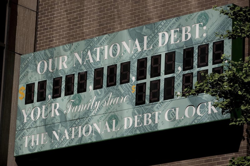 "The National Debt Clock " is displayed on the side of a building near an Internal Revenue Service (IRS) office in New York, U.S., on Thursday, July 14, 2011.