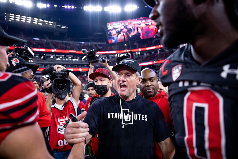 Utah Utes head coach Kyle Whittingham celebrates with players after the Utes beat the Oregon Ducks.