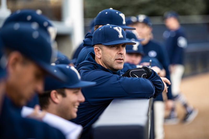 Trent Pratt leans in the dugout during BYU baseball game against Milwaukee in 2019.