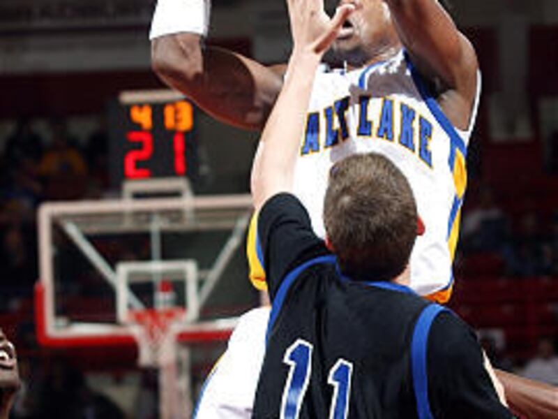 SLCC's Vassy Banny shoots the ball over Southeastern Illinois' Kyle Oldham in the NJCAA quarterfinals on Wednesday.