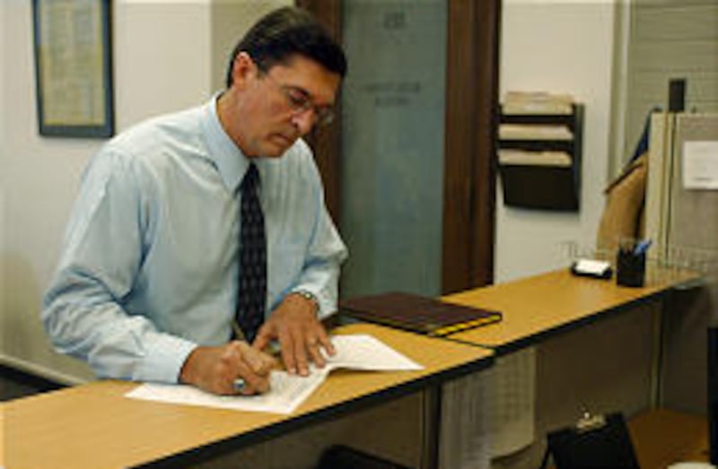Richard Mack files paperwork in the state Elections Office to run for Utah governor as a Libertarian in 2004.