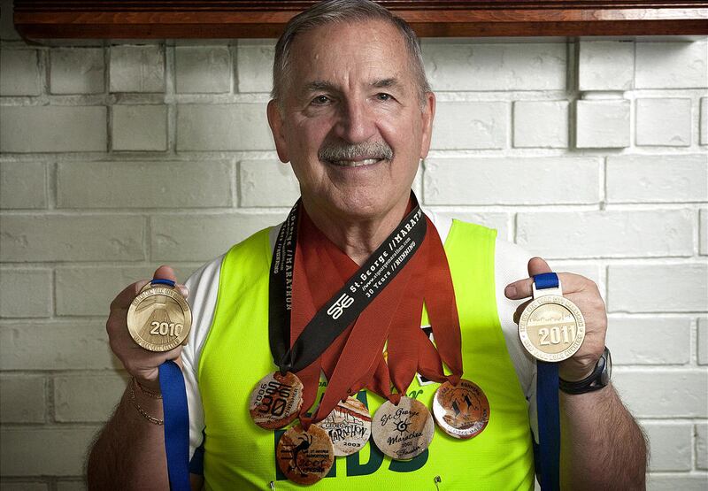 Greg Pratt shows off several of his marathon medals at his home in Orem. Since 2001, Pratt has been sending his marathon finisher medals to the Ladley family of Coltsneck, N.J. James P. Ladley, a partner at Cantor Fitzgerald worked on the 104th floor of t