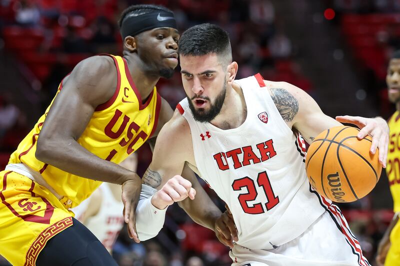 Utah Utes forward Dusan Mahorcic drives into USC Trojans forward Chevez Goodwin during a game at the Huntsman Center in Salt Lake City.
