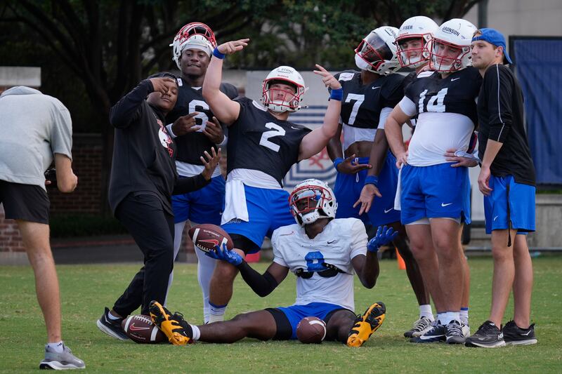 SMU quarterback Preston Stone (2) poses for a photo with Keldric Luster (6), Kevin Jennings (7), Tyler Aronson, Jordan Hudson (8) and other teammates during a practice in Dallas, Friday, Aug. 9, 2024. The Mustangs will play host to BYU Friday night.