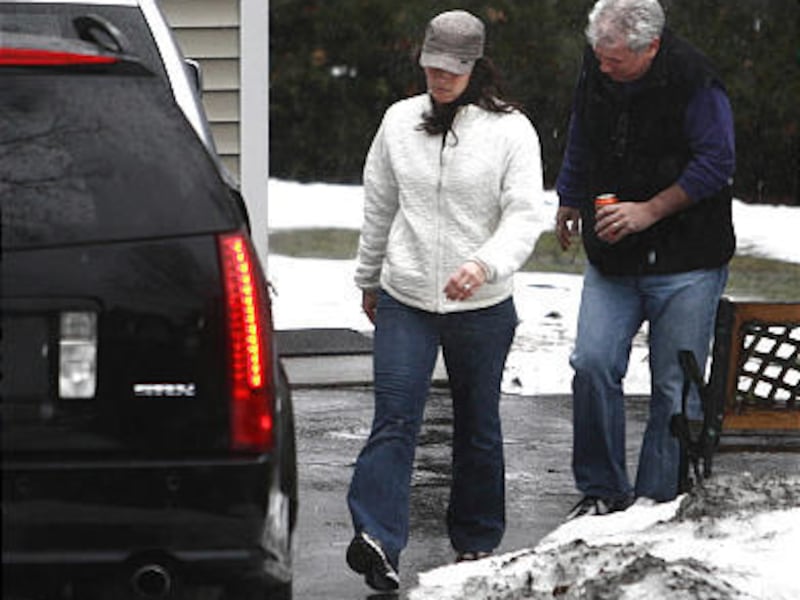 Olympic figure skater Nancy Kerrigan, left, and her husband Jerry Solomon walk toward a vehicle as they depart the home of Kerrigan's parents, in Stoneham, Mass., Monday. Mark Kerrigan, 45, brother of the skater, was charged with assaulting their 70-year-
