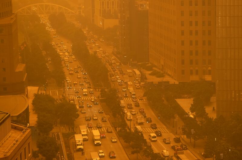 Traffic moves along Wednesday, June 7, 2023, in New York, amidst smokey haze