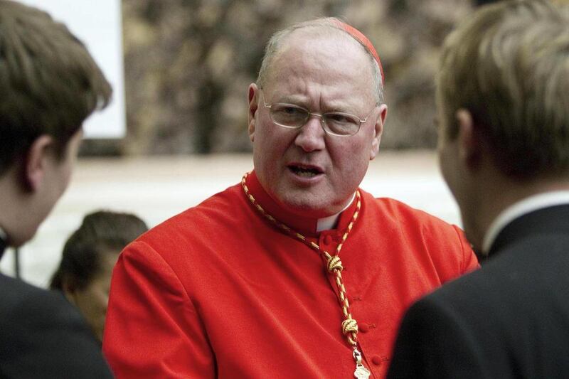 In this file photo from Saturday, Feb. 18, 2012, Cardinal Timothy Dolan, archbishop of New York, is congratulated by two unidentified prelates after being elevated in St. Peter's Basilica at the Vatican. Joseph Amodeo told The Associated Press on Saturda