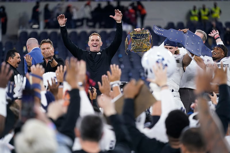 Utah State head coach Blake Anderson celebrates with his team after they won the LA Bowl NCAA college football game 24-13 over Oregon State.