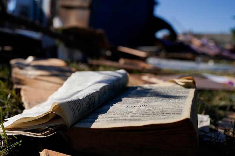 A Bible rests on the lawn of Community Baptist Church in Nashville amongst storm debris Monday, Dec. 11, 2023.