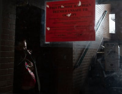 A tenant smokes at the Georgia Apartments in Salt Lake City on Thursday, Feb. 14, 2019. The Salt Lake City fire marshal has extended the 24-hour safety “fire watch” at the complex. Residents have until Saturday at noon to completely evacuate.