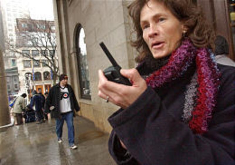 Deborah Bleau, 44, of Latham, N.Y., uses a walkie-talkie to communicate with her daughter Kate Everitt and her two friends in Boston.
