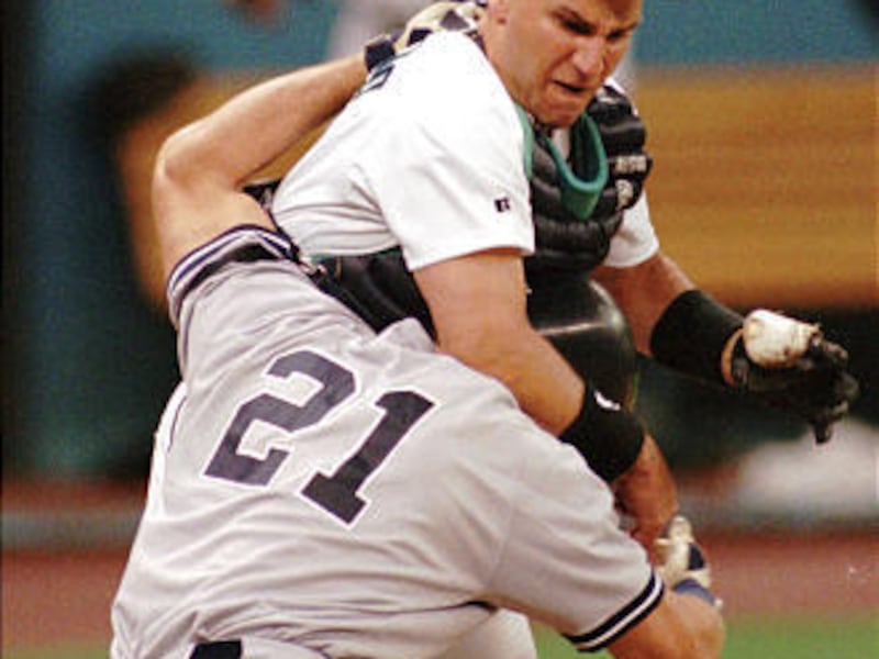 Former Mariners catcher John Marzano, seen here losing his helmet colliding with former Yankee Paul O'Neill in 1996, passed away Saturday.