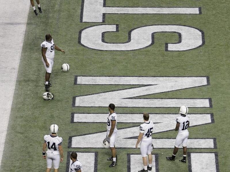 This Dec. 28, 2007 file photo shows Penn State's Tyrell Sales (46) spiking a football over the crossbar following a team photo day at the Alamodome in San Antonio. The NCAA slammed Penn State with an unprecedented series of penalties Monday, July 23, 2012