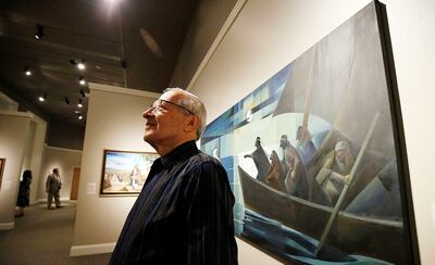 Argentine artist Jorge Cocco Santángelo poses for a photo with some of his artwork at the Church History Museum in Salt Lake City on Thursday, May 17, 2018.