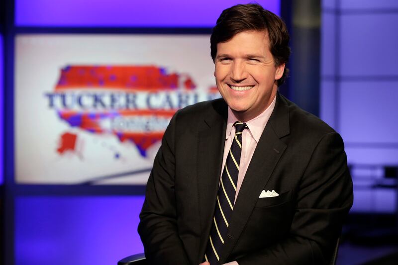Tucker Carlson poses for photos in a Fox News Channel studio in New York in 2017.