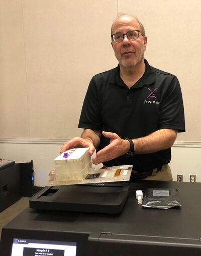 In this photo taken November 16, 2018, Stephen Meer, chief information officer from ANDE, demonstrates in Chico, Calif., his company's Rapid DNA analysis system, which is being used to try to ID victims of the Northern California wildfire.