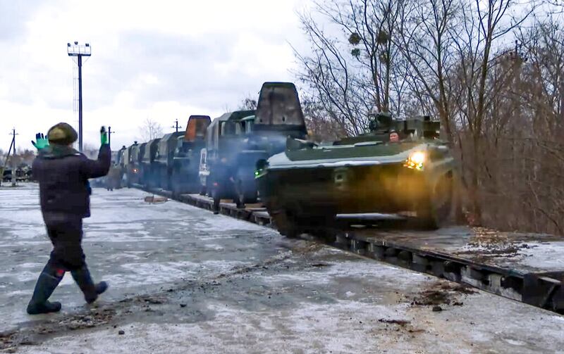 A Russian armored vehicle drives off a railway platform.
