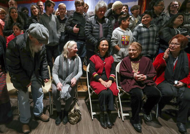Pema Chagzoetsang, former president of the Utah Tibetan Association, center, smiles as people on the Interfaith Bus Tour gather for a photograph as they visit the Tibetan Community Center in Salt Lake City on Tuesday, Feb. 19, 2019. As part of Interfaith