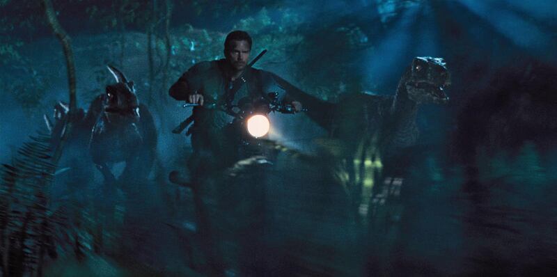Chris Pratt is surrounded by raptors in “Jurassic World.”