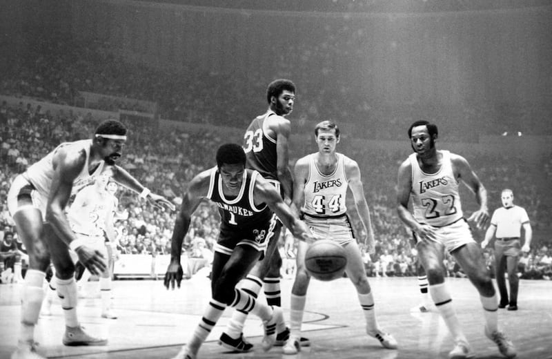 Milwaukee Bucks' Oscar Robertson (1) is seen in dribbling action, with teammate Lew Alcindor (33), Jerry West (44), Elgin Baylor (22), and Wilt Chamberlain of the Los Angeles Lakers looking on; during a game between the Los Angeles Lakers and the Milwauke