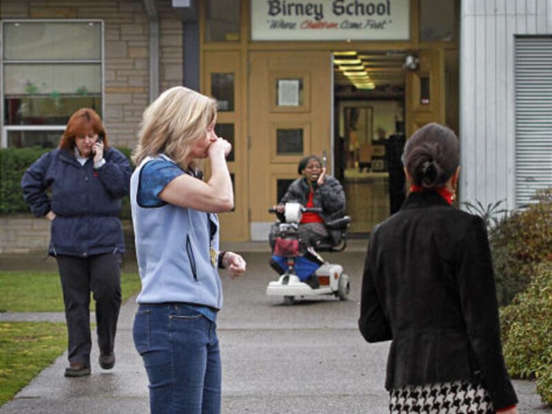 Teachers and staff members react after after a special education teacher at Birney Elementary School in Tacoma Wa., was shot and killed Friday.