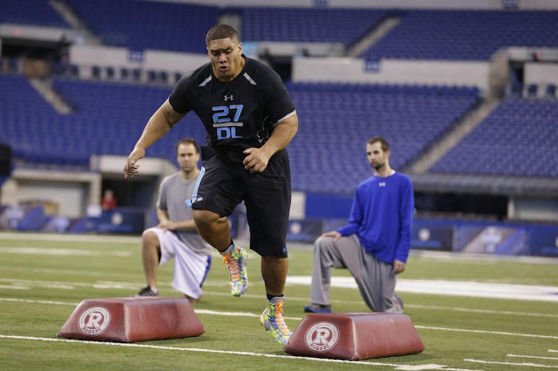 BYU defensive lineman Eathyn Manumaleuna runs a drill at the NFL football scouting combine in Indianapolis, Monday, Feb. 24, 2014.