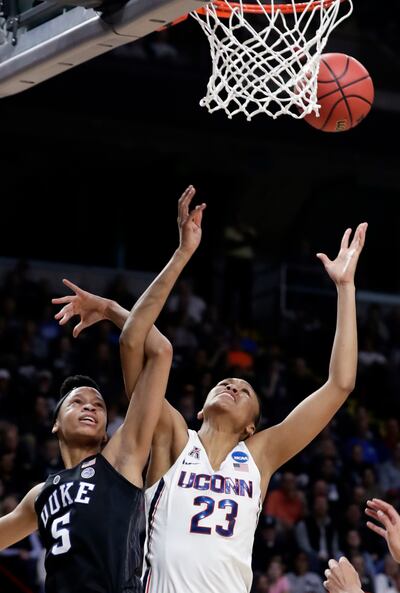 Duke's Leaonna Odom (5) and Connecticut's Azura Stevens (23) fight for control of the ball during the first half in a regional semifinal at the NCAA women's college basketball tournament Saturday, March 24, 2018, in Albany, N.Y. (AP Photo/Frank Franklin I