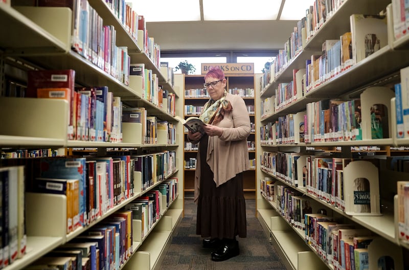 Wanda Mae Huffaker, a librarian with Salt Lake County Library, flips through a book.