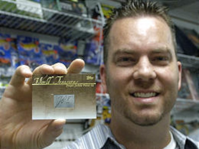 Jeff Hoekstra, manager of a collectibles store, holds the Pope John Paul II card he is trying to sell on eBay.