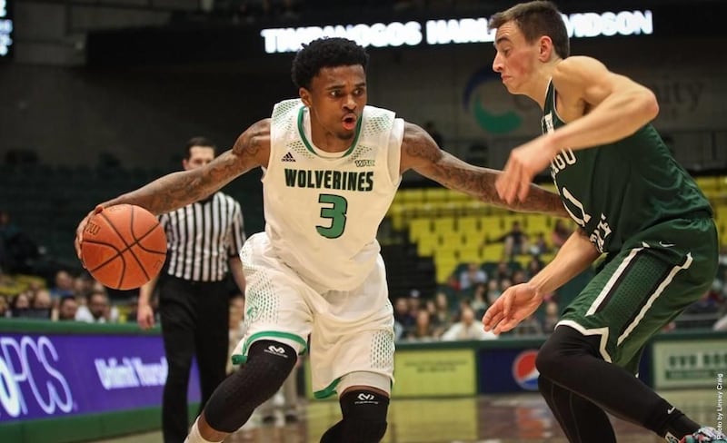 Donte Williams (left) drives by his defender. Utah Valley travels to play conference foe Seattle U on Saturday night.