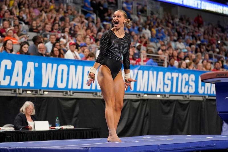 Utah’s Abby Brenner celebrates after competing in vault during the semifinals of the NCAA women’s gymnastics championships.