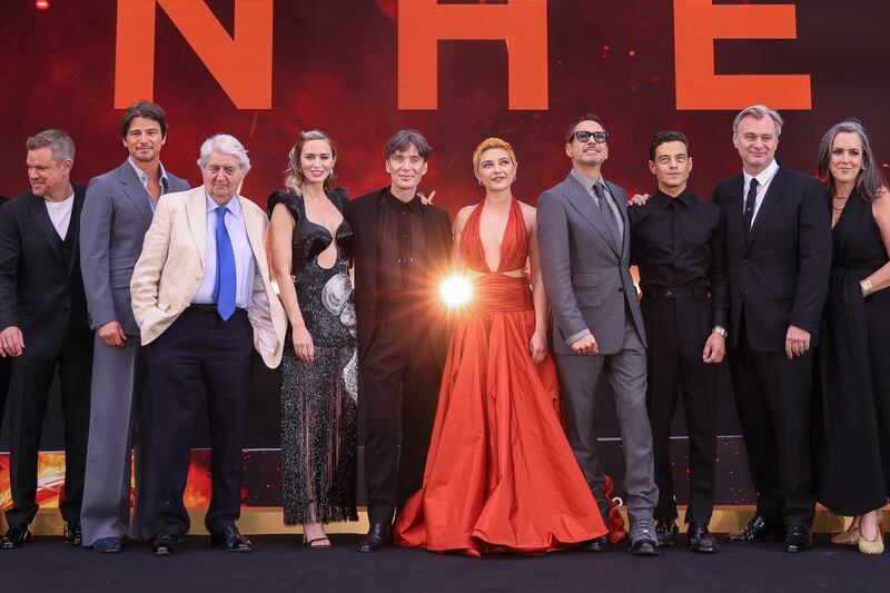 Matt Damon, from left, Josh Hartnett, Tom Conti, Emily Blunt, Cillian Murphy, Florence Pugh, Robert Downey Jr., Rami Malek, director Christopher Nolan and producer Emma Thomas pose for photographers upon arrival at the premiere for the film “Oppenheimer” in London.