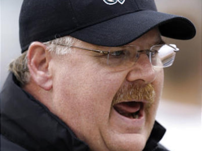 This is a Nov. 1, 2009, file photo showing Philadelphia Eagles coach Andy Reid talking with players on the bench during the first quarter of a game against the New York Giants in Philadelphia. Eagles coach Andy Reid has signed a contract extension that wi