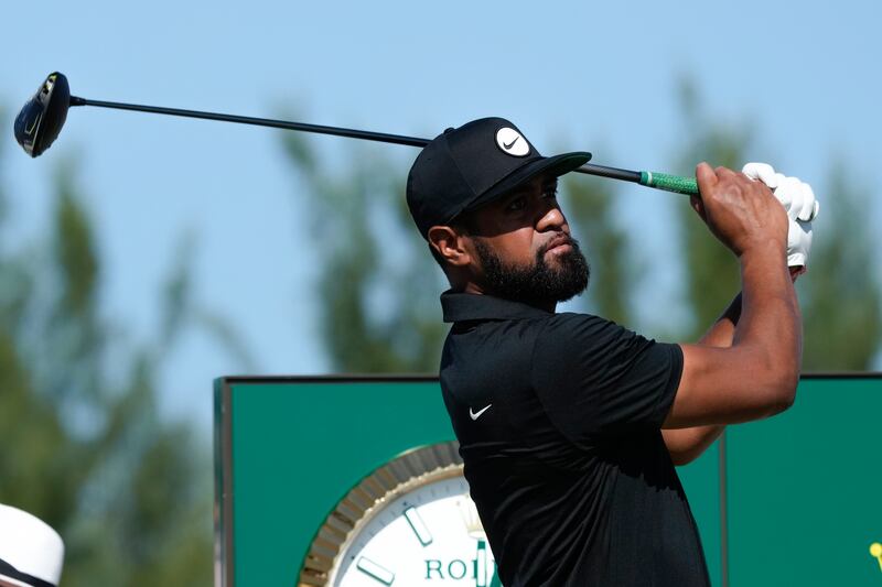 Tony Finau, of the United States, watches his shot from the first tee