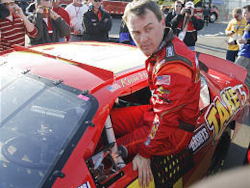 Trying to keep a low profile after Thursday's crash, driver Kevin Harvick climbs out of his Busch car Friday at Daytona International Speedway.