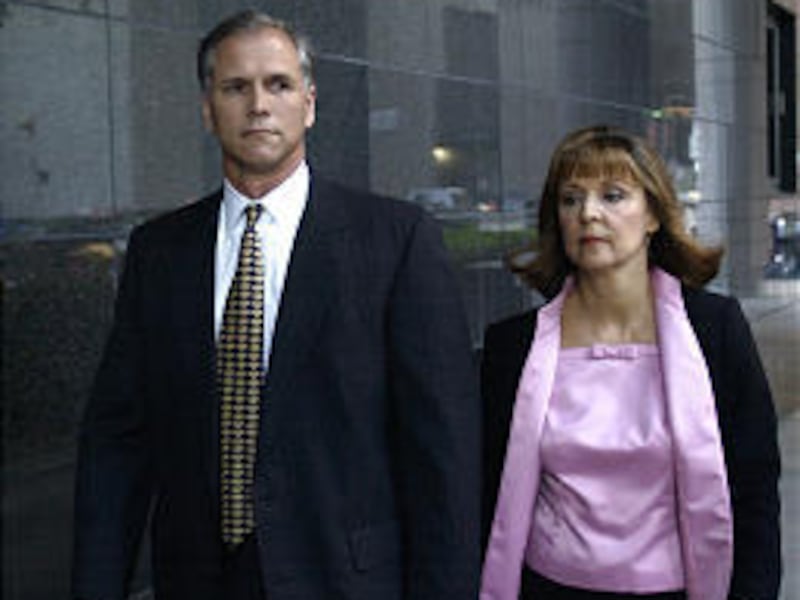 Former Enron finance executive Dan Boyle, left, and his wife enter the federal courthouse in Houston where he is among the defendants.