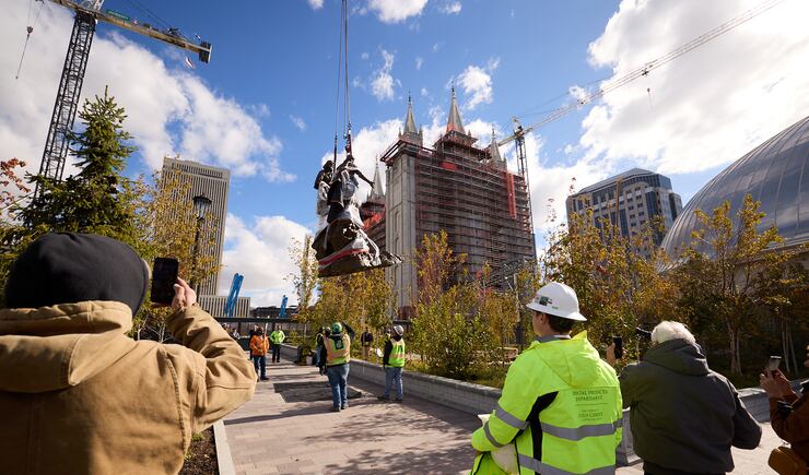 Construction workers lower a portion of the First Vision statue to be set on Temple Square on Wednesday, Nov. 6, 2024.