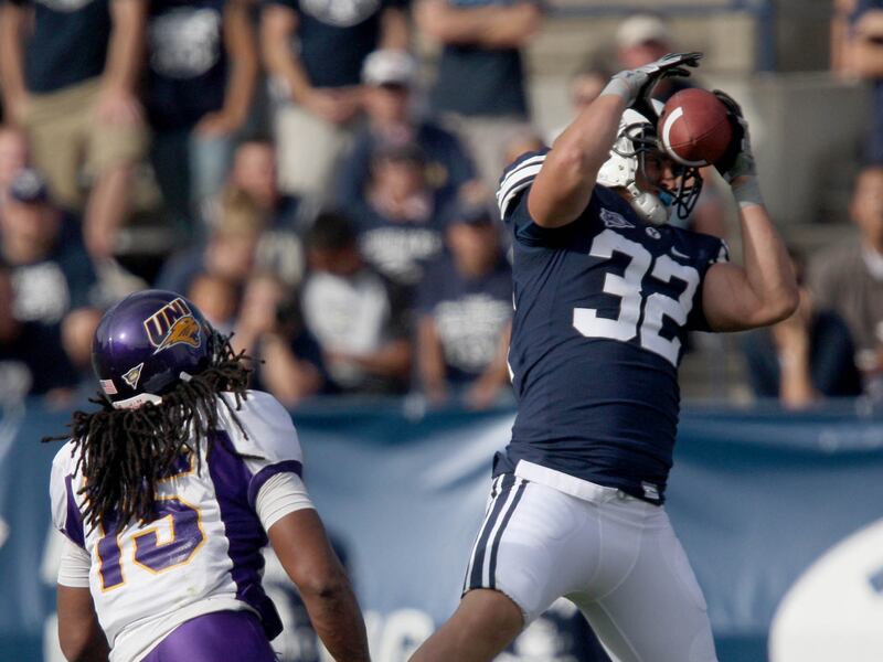 BYU tight end Dennis Pitta (32) makes a reception over University of Northern Iowa defender De’Veon Harris on Aug. 30, 2008.
