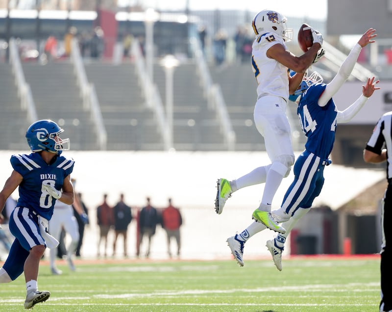Orem's Puka Nacua pulls in a long pass for a first down after multiple penalties set up a first-and-41 play in the 4A football state championship game against Dixie at Rice-Eccles Stadium in Salt Lake City on Friday, Nov. 16, 2018.