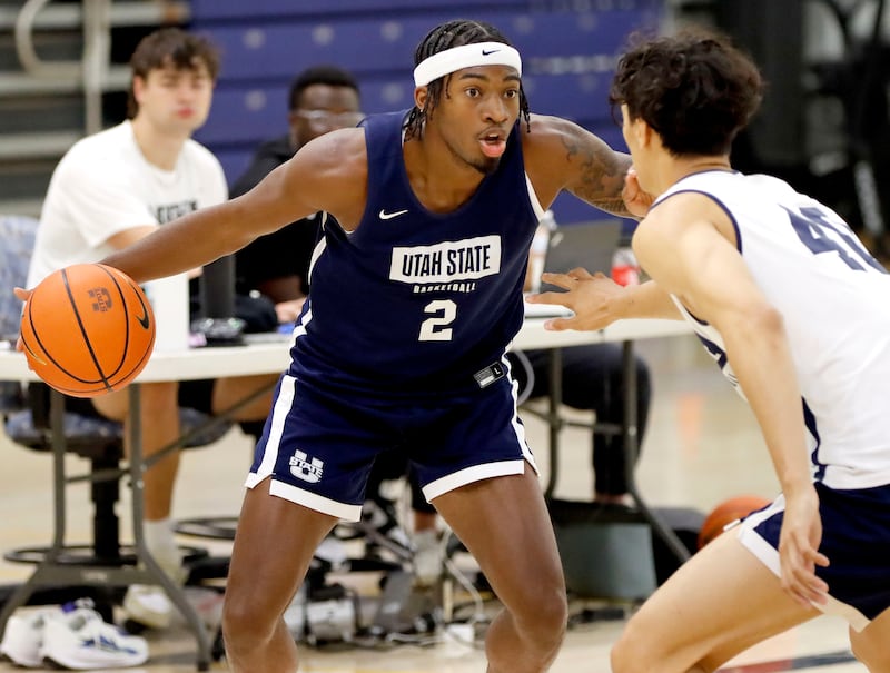 Utah State senior guard MJ Collins, a transfer from Vanderbilt, looks to drive against freshman wing Kingston Tosi during USU’s early-morning practice Tuesday at the Wayne Estes Center in Logan.