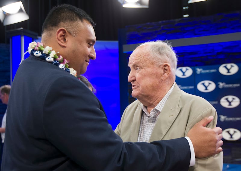 BYU's new head football coach Kalani Sitake talks briefly with former head coach LaVell Edwards, following a press conference in Provo, Utah, Monday, Dec. 21, 2015. Sitake played for Edwards during his career.