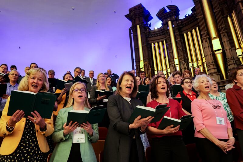 Baroness Emma Nicholson of Winterbourne, center, and members of the AMAR Foundation Windsor Dialogue Series Conference sing.