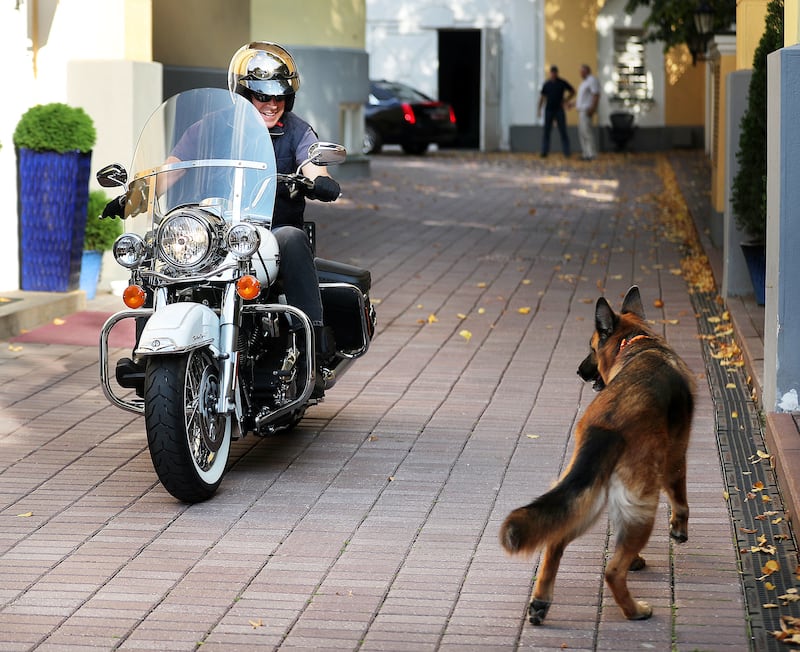 Ambassador Jon M. Huntsman Jr. is greeted by his dog Samy as he returns from a motorcycle ride in Moscow, Russia, on Saturday, Sept. 22, 2018.