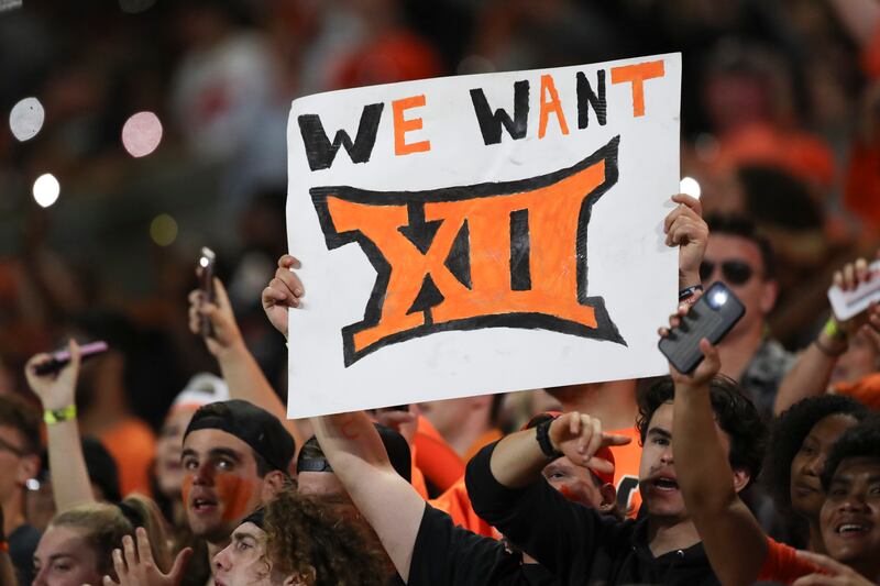 An Oregon State fan holds up a sign reading ‘We Want XII’ during a game against UC Davis, Sept. 9, 2023, in Corvallis, Ore.