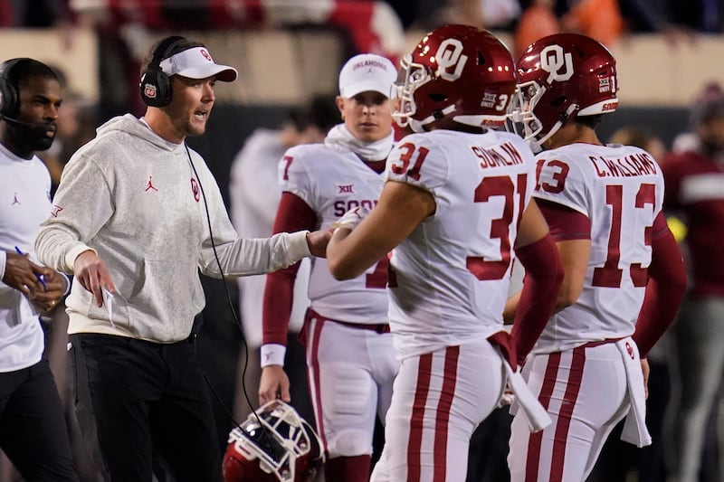 Oklahoma head coach Lincoln Riley talks with players during game against Oklahoma State, Nov. 27, 2021, in Stillwater, Okla.