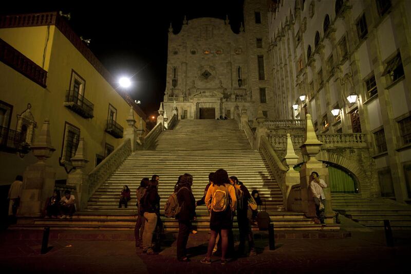 Students stand outside the Guanajuato University building in the colonial city of Guanajuato, Mexico. The charming city is one of the most picturesque places in Mexico.