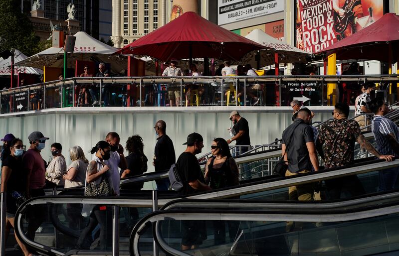 People walk as others dine on the Las Vegas Strip.