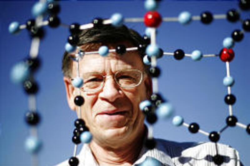 Chemistry professor Joel S. Miller looks through a model of the structure of an organic magnet.