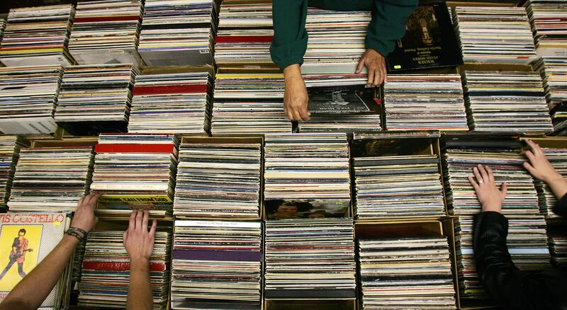 Vinyl record enthusiasts scan boxes of records for titles during at Randy's Record Shop in Salt Lake City on Oct. 17, 2008.